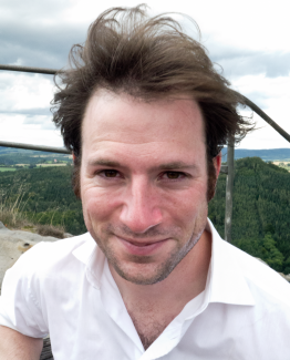 Photograph of Dr. Lars Meyer with mountains in background