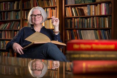 Kim Waters in front of bookcase