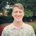 Photograph of Kyle Vanderniet outside in front of greenery