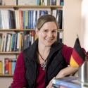 Photograph of Dr. Vera Lee-Schoenfeld in front of bookshelves